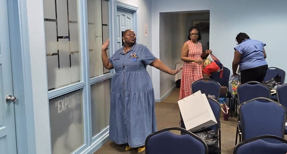 An HRMAB member celebrating with arms outstretched after the ceremony