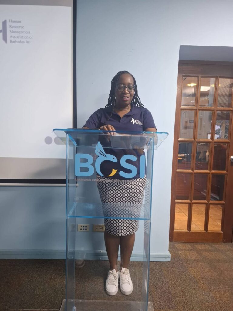 HRMAB representative in a branded polo speaking from the lectern